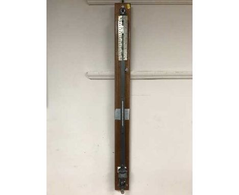 A marine barometer on mahogany bracket