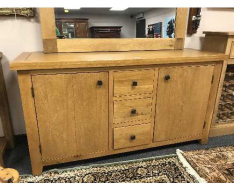 A light oak sideboard fitted with three drawers