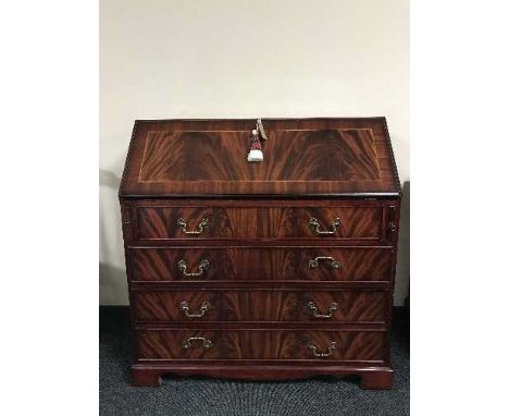 An inlaid mahogany writing bureau on bracket feet 