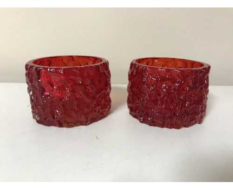 A pair of ruby red Whitefriars cylindrical bark candle holders designed by Geoffrey Baxter, height 6 cm 