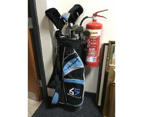 A Dunlop golf bag containing a part set of Dunlop golf clubs 