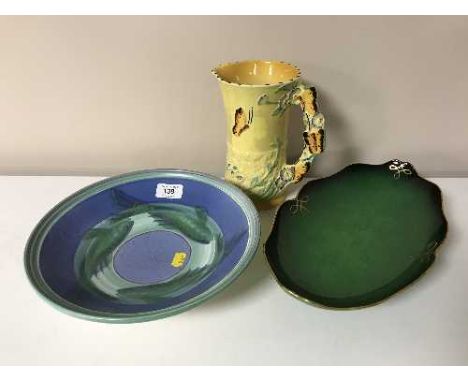 A circular Poole pottery shallow bowl depicting fish together with a green Carltonware Verte Royale shallow dish and a 20th c
