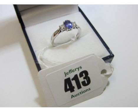 DIAMOND & TANZANITE RING, 18ct white gold 3 stone ring set a tanzanite to centre with diamonds to either side.  Ring size L/M