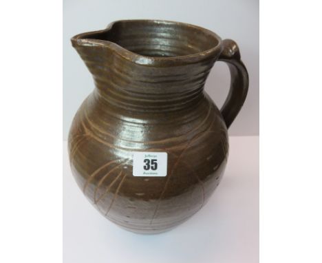 MICHAEL CARDEW POTTERY; A large pottery water jug with incised decoration on a brown ground. Michael Cardew pottery mark to b