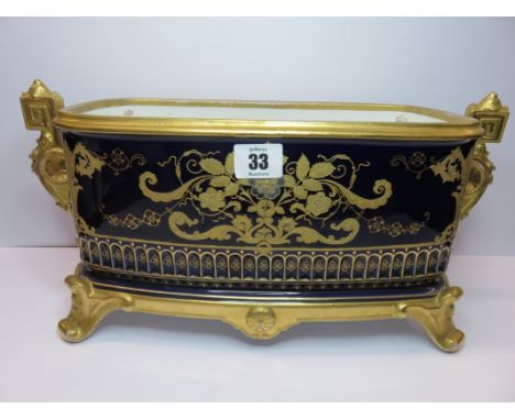 CONTINENTAL PORCELAIN FLOWER TROUGH, gilded blue ground with ornate handles and scroll feet, 7.5" height, 15.5" width