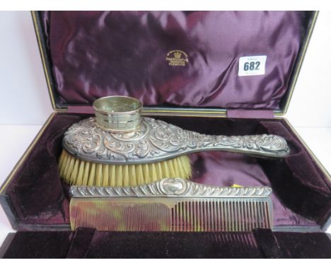 SILVER DRESSING TABLEWARE, an ornate embossed dressing brush and comb set and a oval silver serviette ring