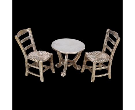 A German 800 silver miniature doll's dining set, comprising tripod table and pair of rush-seated chairs, chair height 3.5cm, 