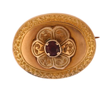A Victorian garnet memorial brooch, unmarked yellow metal closed-back settings, of oval form with central engraved flowerhead