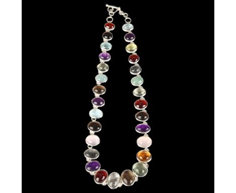 A modern sterling silver graduated gemstone line necklace, maker YC, each panel bezel set with oval cabochon gemstones, inclu