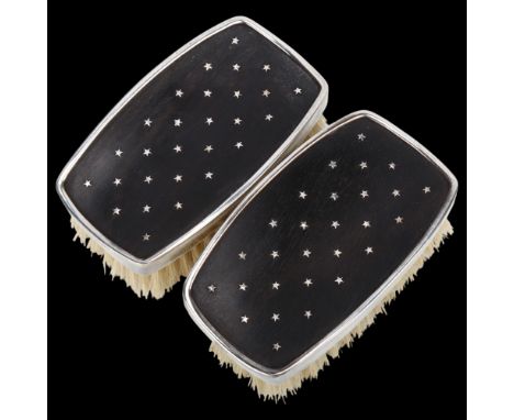 A pair of Elizabeth II silver-mounted ebony dressing table brushes, Leslie Gordon Durbin, London 1957, with pique star decora