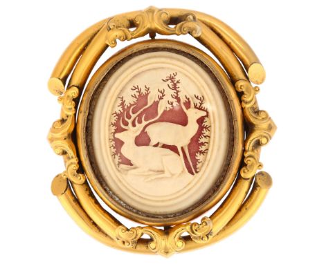 A large Victorian gilt-metal double-sided swivel memorial brooch, 1 panel having inset carved staghorn panel, reverse with bl