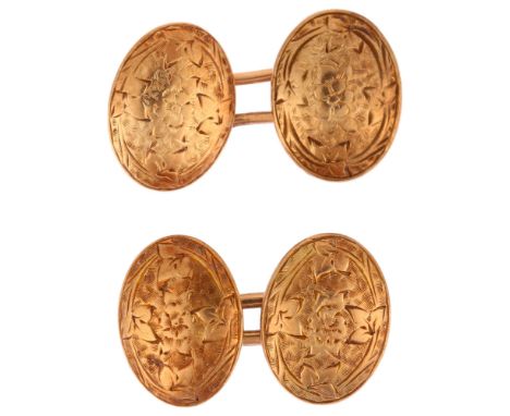 A pair of early 20th century rose gold oval cufflinks, maker JT, unmarked gold panels with engraved floral decoration, panel 