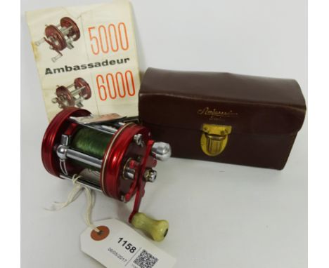 ABU Ambassadeur 6000 multiplier fishing reel, red anodised finish with spares, spanner, oiler and instructions in leather cas