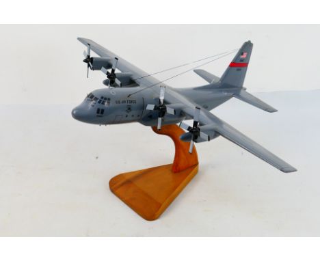 A large unboxed travel agent style desk display model depicting a Lockheed Martin C-130 USAF Hercules. The model measures app