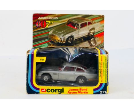 Corgi Toys - A boxed Corgi Toys #271 James Bond Aston Martin. The 1:36 scale model in silver with red interior has some age w