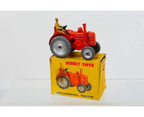 Dinky - A boxed Field Marshall tractor with silver wheel hubs # 301. The model appears in Very Good condition with light sign