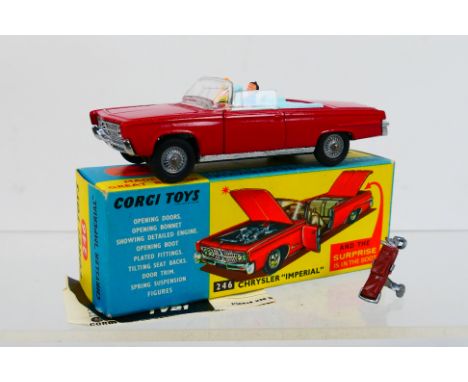 Corgi Toys - A boxed Corgi Toys #264 Chrysler Imperial. The model in red with pale blue interior,cast hubs, driver and passen