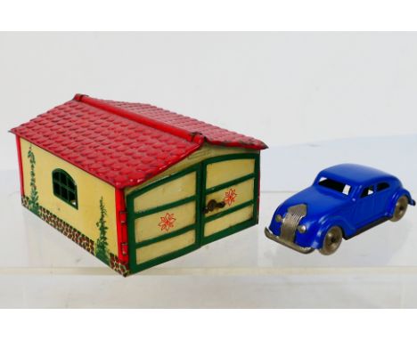 Gnom Lehmann - A rare German pressed metal Gnom Chrysler Airflow car in blue# 807 with its own double garage # 806. The model
