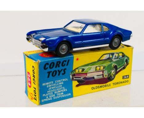 Corgi Toys - A boxed Corgi Toys #264 Oldsmobile Toronado. The model in metallic dark blue with off-white interior, pop-up hea