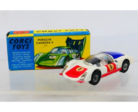 Corgi Toys - A boxed Corgi Toys #330 Porsche Carrera 6. The model with white body, red bonnet and doors, cast hubs, and blue 