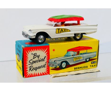 Corgi Toys - A boxed Corgi Toys #430 Ford 'Bermuda' Taxi. The model with white body, with lime green and red canopy, yellow i