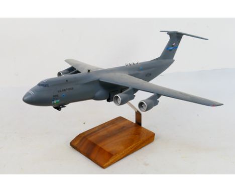 A large unboxed travel agent style desk display model depicting a Lockheed Martin USAF C-5A Galaxy . The model measures appro