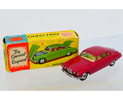 Corgi Toys - A boxed Corgi Toys #238 Jaguar Mk.X. The model in metallic Cerise with lemon interior, spun hubs, plus two brown