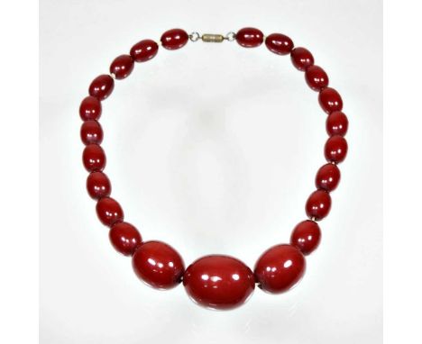 A cherry bakelite amber single strand graduated bead necklace, 40cm longLargest bead approximately 30 x 25mm. 62g gross weigh