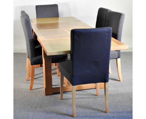 A modern light oak extending dining table, with two additional leaves, together with a set of six upholstered dining chairs (