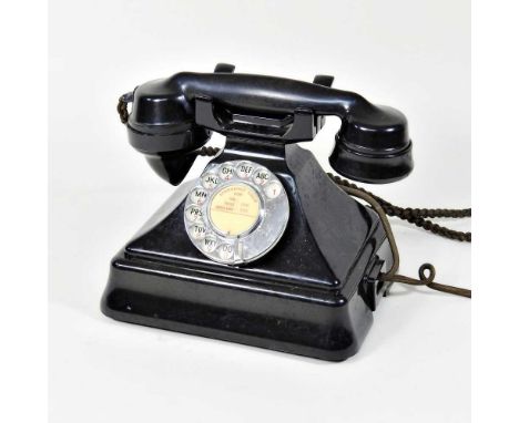 A black bakelite rotary dial telephone