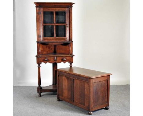 An oak standing corner cabinet, 75cm wide, together with an early 20th century oak coffer, 93cm wide (2)75w x 45d x 177h cm