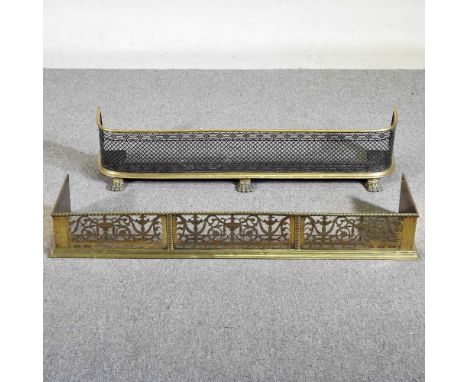 A pierced brass fender, 108cm wide, together with another, 106cm wide (2)108w x 28d x 15h cm