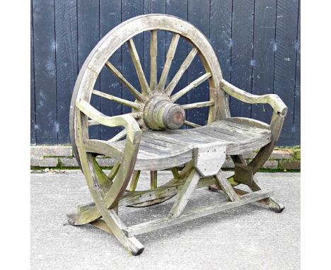 A teak garden bench, with a cartwheel back114w x 66d x 119hcm 