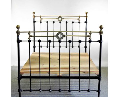 An early 20th century brass and iron bedstead, with a slatted wooden base137w x 210d x 150h cmInternal measurements for mattr