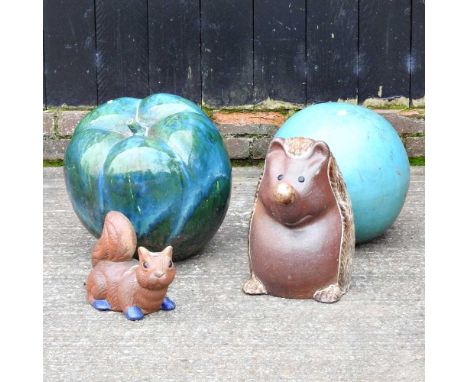 A glazed pottery garden marker and three various ornaments to include a hedgehog, 38cm high (4)