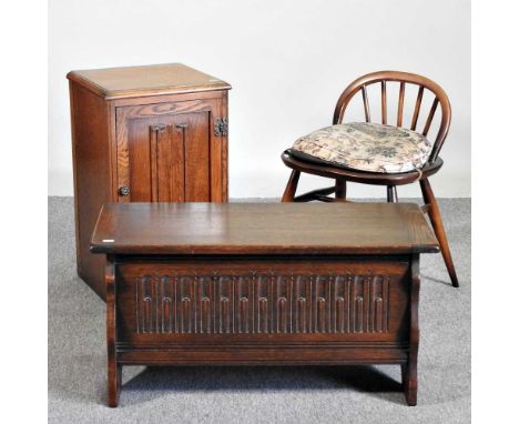 A 1970's Ercol dark elm dressing table stool, together with an oak coffer, 80cm wide and a pot cupboard (3)80w x 34d x 40h cm