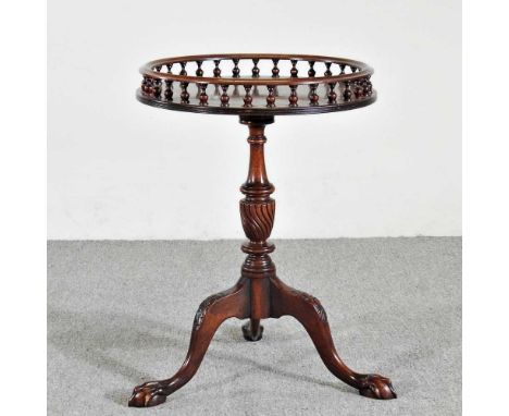 A reproduction occasional table, with a gallery top, on a tripod base