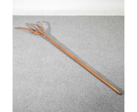 A vintage wooden hay fork