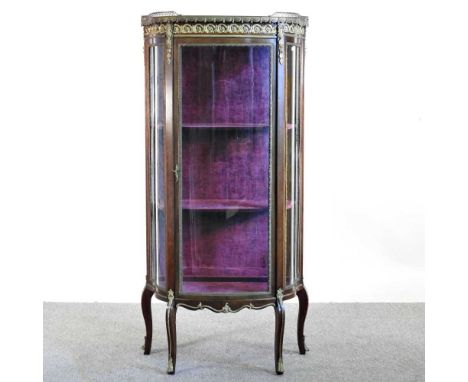 A Louis XV style marble top vitrine, 20th century, with gilt metal mounts, enclosed by a glazed door69w x 33d x 141h cm