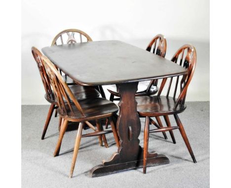 A 1970's Ercol dark elm dining table, together with five wheelback dining chairs (6)145l x 76d x 72h cm
