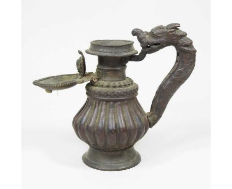 An antique bronze lamp, probably 19th century South East Asia, with a fluted baluster body and dragon handle, 15cm high