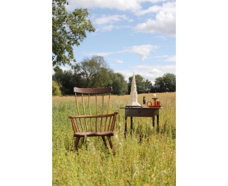 A large ash and elm comb-back Windsor armchair, 18th century, with a saddle seat,  68cm wide 57cm deep 104cm highThe Accumula