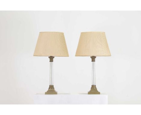 A pair of gilt-metal and moulded glass column lamps, 20th century, each in the form of a wrythen twist column, surmounted by 