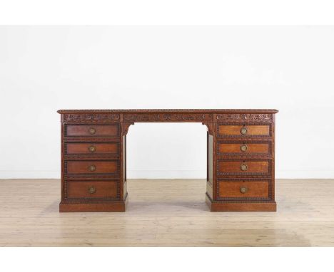 A Victorian oak twin-pedestal desk in the George II taste, late 19th century, with all-over carved decoration, 165cm wide68cm