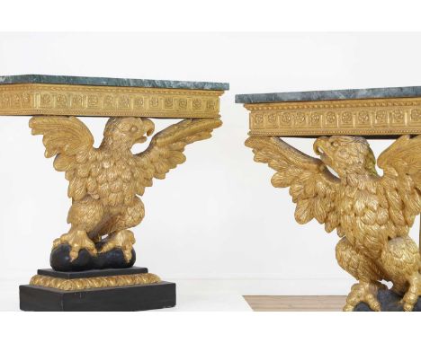 A pair of George II-style carved giltwood console tables,20th century, in the manner of William Kent, each with a serpentine 