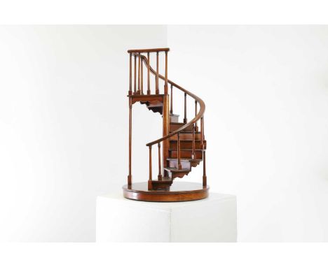 A turned wooden model of a staircase,20th century, with spiral balustrades,36cm diameter61.5cm highCondition ReportLosses to 