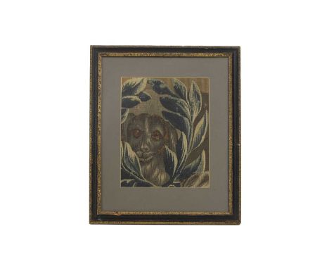 A verdure tapestry fragment,17th/18th century, French, depicting a dog amongst foliage,30 x 24cm, in a parcel-gilt glazed fra