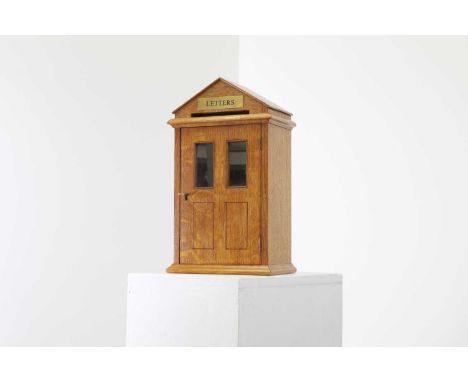 A golden oak letter box,20th century, of architectural form, 23cm wide15cm deep39cm high