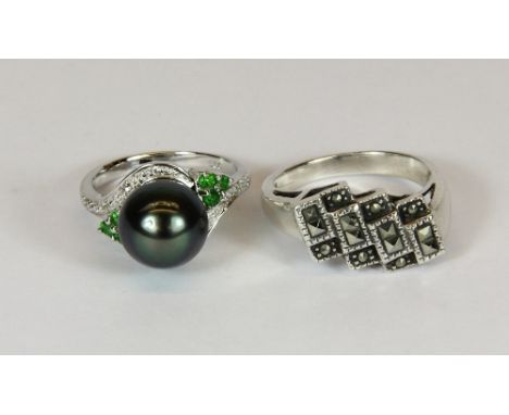 A silver black pearl and stone set ring and a further silver and marcasite ring