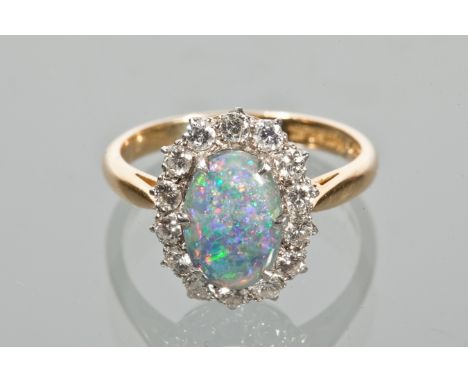 BLACK OPAL AND DIAMOND CLUSTER RING
the oval opal of approximately 1.35 carats surrounded by diamonds totalling approximately